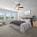 Bedroom with carpet, three windows and ceiling fan