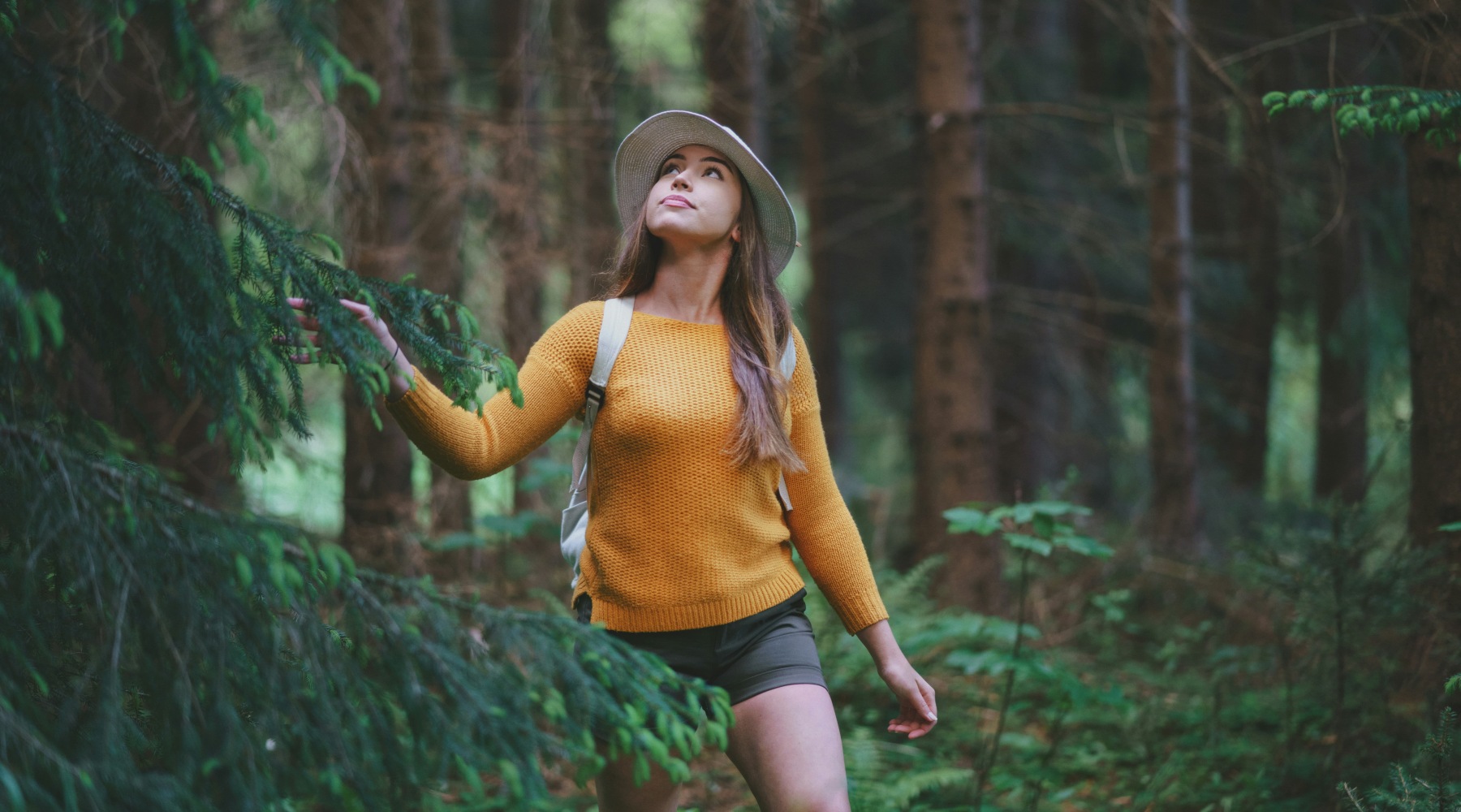 a woman walking in a forest